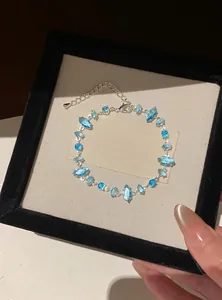 Detail of a zircon adjustable bracelet with light blue marquise stones in a box.