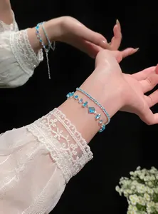 Close-up detail showing a double-layered blue zircon adjustable bracelet on an elegant wrist