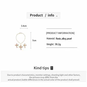 Detail view showing resin and pearl lip cross jewelry specifications and size measurements.
