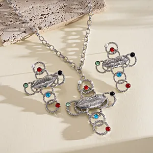 Close-up of retro silver lip and cross jewelry set with colorful resin stones