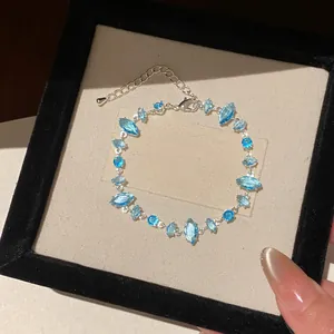 Elegant silver adjustable bracelet featuring marquise-cut blue zircons in a luxury box