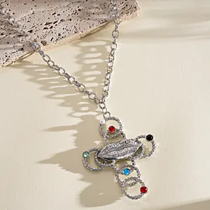 Detail view of retro silver cross necklace featuring unique lip motif and colorful stones