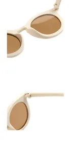 Detailed macro shot of beige kids sunglasses frames and brown lenses hinges