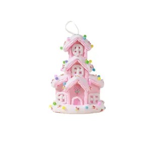 Decorative pink gingerbread house Christmas tree hanging ornament with colorful pom-poms