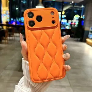 Close-up of orange quilted leather phone case with raised camera protection frame