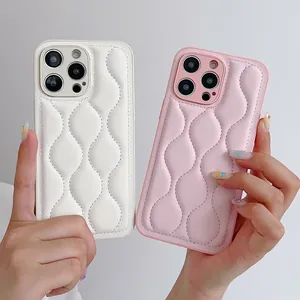 Close-up of quilted wave pattern on leather phone case in cream and pink
