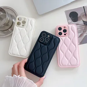 Macro detail of puffy quilted leather phone case in white black and pink colors