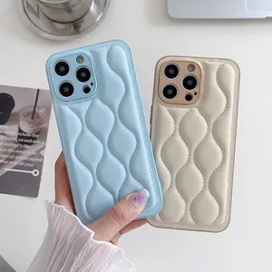 Close-up of quilted leather puffer cases for iPhone showing wavy texture and stitching