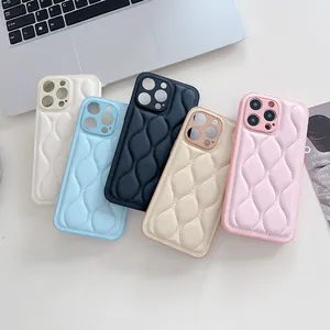 Macro detail of quilted leather puffer cases for iPhone showing texture and pastel colors