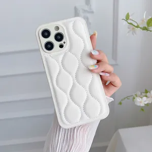 Close-up of beige quilted leather texture and wave pattern on iPhone case