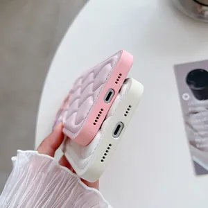 Detail view of precise bottom cutouts for pink and white quilted puffer phone cases