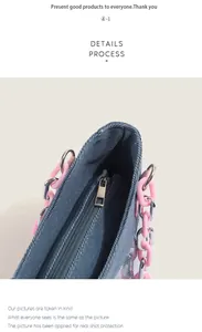 Close-up of denim tote bag with pink acrylic chain handle and metal zipper closure