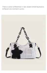 Detail of white canvas crossbody bag with black star patches and plastic chain handle