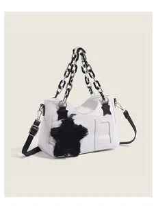Detail of canvas crossbody bag with star patch and plastic chain handle