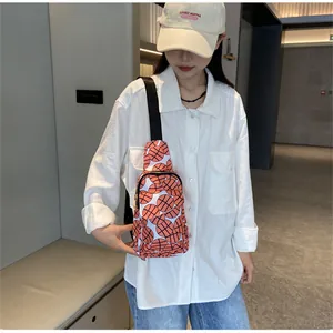 Detailed view of women's nylon chest bag with vibrant basketball pattern print