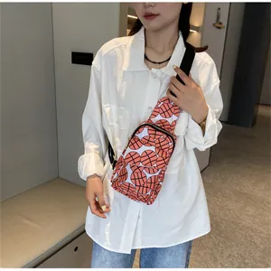 Stylish nylon chest bag with vibrant orange basketball pattern worn by a female model