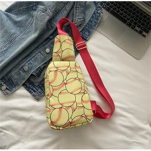 Close-up detail of a yellow nylon chest bag with creative red baseball print and strap