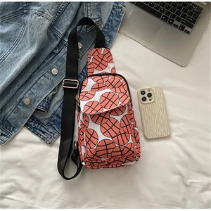 Close-up detail of sporty nylon crossbody chest bag with vibrant basketball pattern
