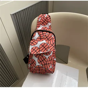 Detailed view of a nylon chest bag featuring an all-over basketball print pattern.