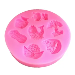 Pink silicone mold with fish and ingot shapes for Chinese New Year fondant cakes