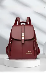 Detailed front view of wine red leather backpack with elegant gold kangaroo logo.