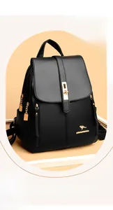 Detailed view of stylish black pebbled leather women's backpack with golden kangaroo logo