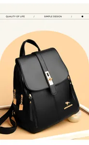 Detailed front view of a fashionable black textured leather backpack with golden kangaroo logo
