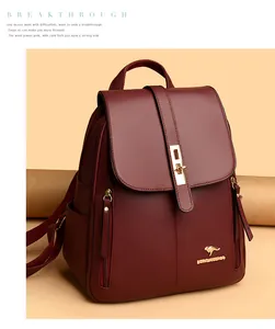 Close-up of a stylish burgundy leather backpack with a gold kangaroo logo accent