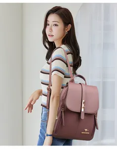 Professional lifestyle shot of a mauve stylish women's backpack worn by a model