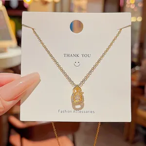 Macro shot of gold-plated Gourd necklace pendant with sparkling zircon inlays