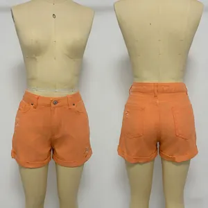 Front and back views of high-waisted distressed orange denim shorts for women