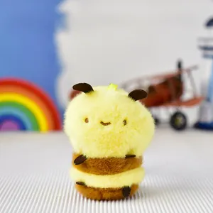 Macro view of a cute yellow bee plush keychain with soft fluffy texture