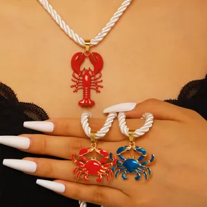 Detailed view of red lobster and vibrant crab pendants on stylish white rope chain necklaces