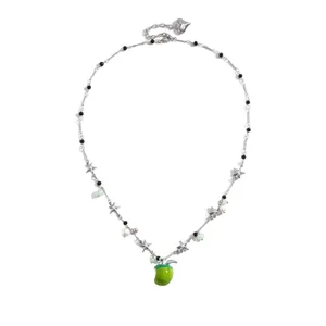 Sweet dopamine style necklace featuring silver stars, pearls, and a vibrant green apple pendant