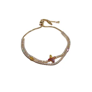 Sparkling gold adjustable bracelet with colorful zirconia flower motif and sliding clasp.