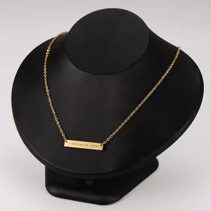 Gros plan d'un collier barre dorée avec gravure 'A mother's hug lasts a lifetime'