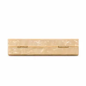 Acrylic evening clutch bag featuring a marbled texture and golden metal hinges