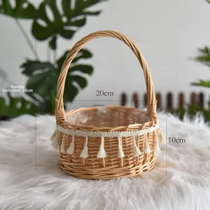Close-up detail of a handmade woven wicker basket with handle and white tassels