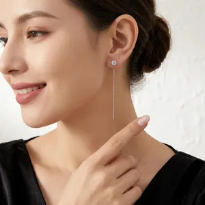 Elegant S925 sterling silver moissanite long tassel earrings worn by a smiling model.