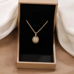 Vintage gold rope chain necklace with elegant oval cat eye stone pendant in jewelry box