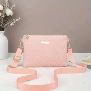 Elegant pink chevron quilted crossbody bag with gold-tone hardware and adjustable strap
