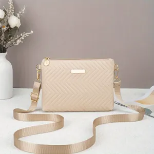 Minimalist beige chevron quilted crossbody bag with gold hardware for daily commuting
