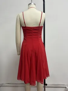 Back view of a red spaghetti strap evening dress with a pleated flared midi skirt.
