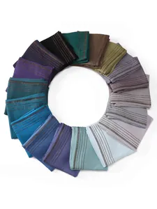 Detailed close-up of multiple colorful jersey scarves with sparkling rhinestone trim