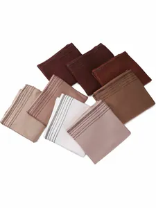 Detailed view of jersey diamond scarves in a variety of earth tones with rhinestone trim