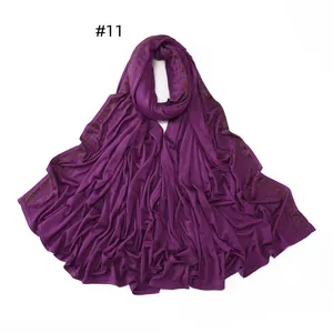 Detailed view of dark purple jersey scarf featuring exquisite gold beaded edge trim