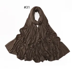 Detailed view of dark brown jersey scarf featuring delicate rhinestone edge embellishments
