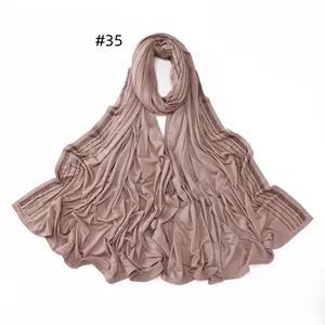 Detail of dusty pink mercerized cotton hijab featuring elegant rhinestone borders
