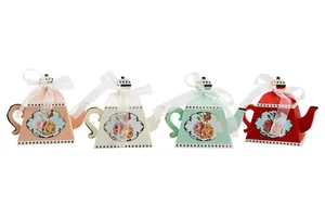 Close-up of elegant teapot-shaped favor boxes with vintage rose prints and gold accents