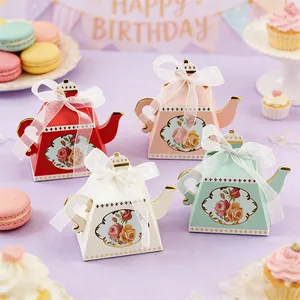 Assorted teapot-shaped paper favor boxes featuring floral prints and white ribbon bows